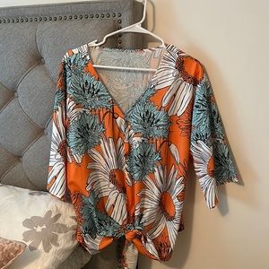 Bright, beautiful floral shirt with v- neck and bottom tie.